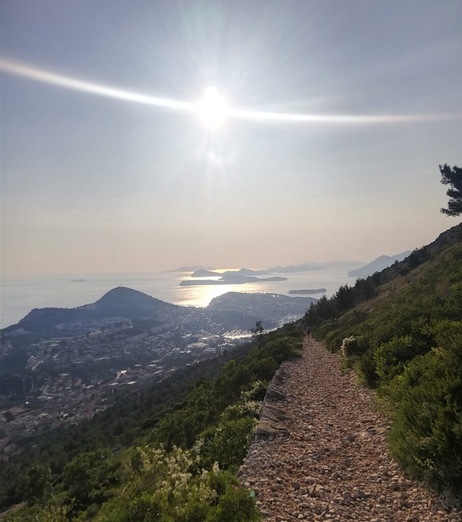 Sun shining from the slopes of mount Srđ over the Elaphites islands