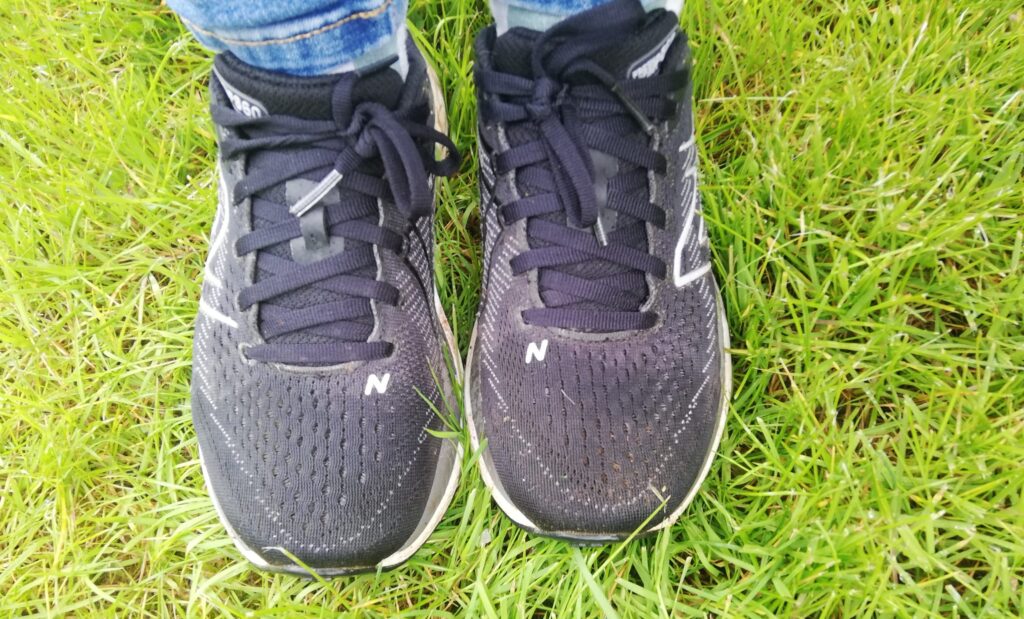 Wet toes of trainers on grass