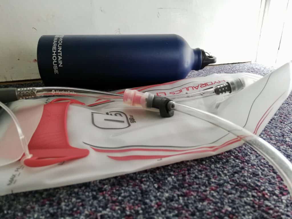 Hydration bladder and bottle side by side.