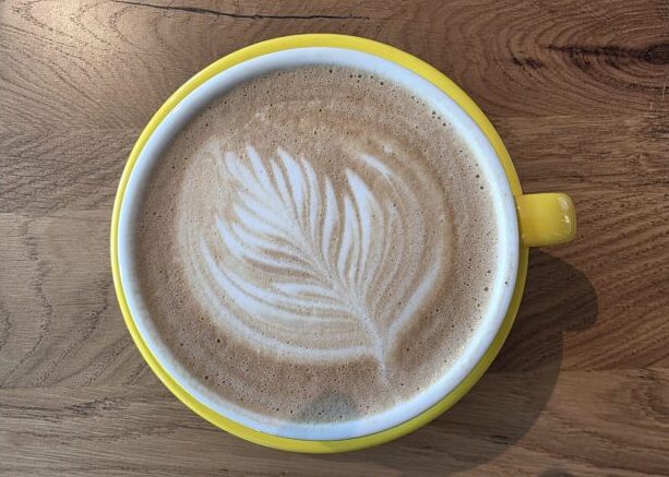Yellow Latte coffee in cup and saucer