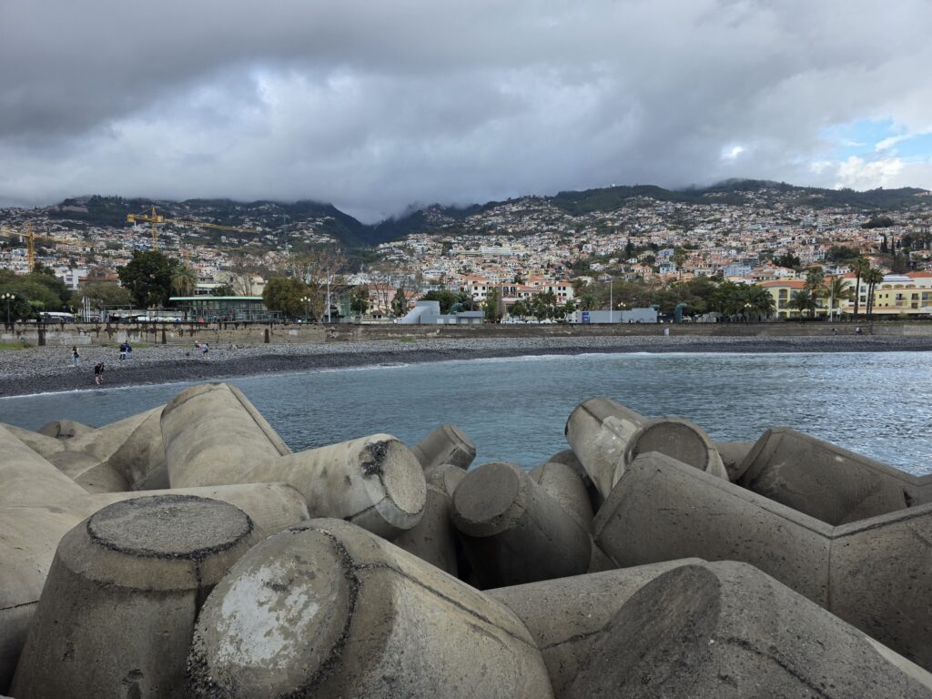 Break water with lighthouse looking back on Funchal seafront.