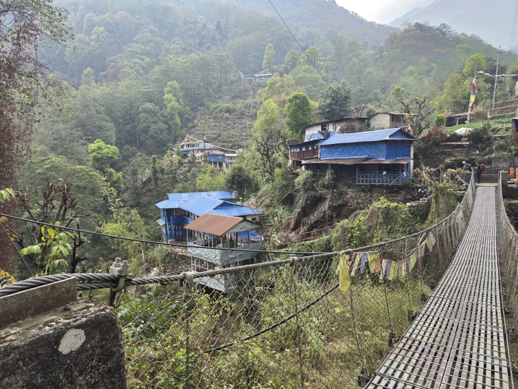 Villages along the Annapurna sanctuary route with traditional metal bridge across the valley